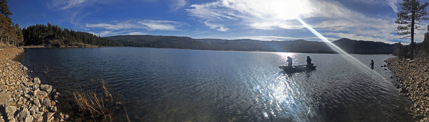 Round Valley Reservoir, with anglers fishing from a boat and wading near shore